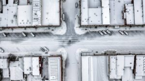 Aerial of urban businesses covered in snow