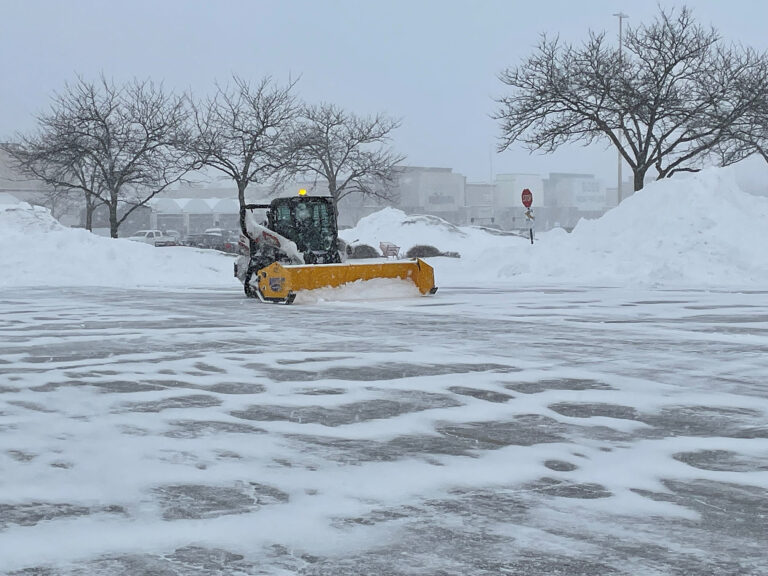 Snow pusher in parking lot